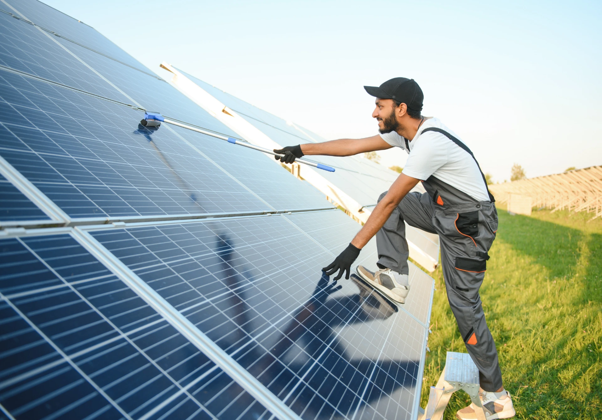 worker cleaning solar panels